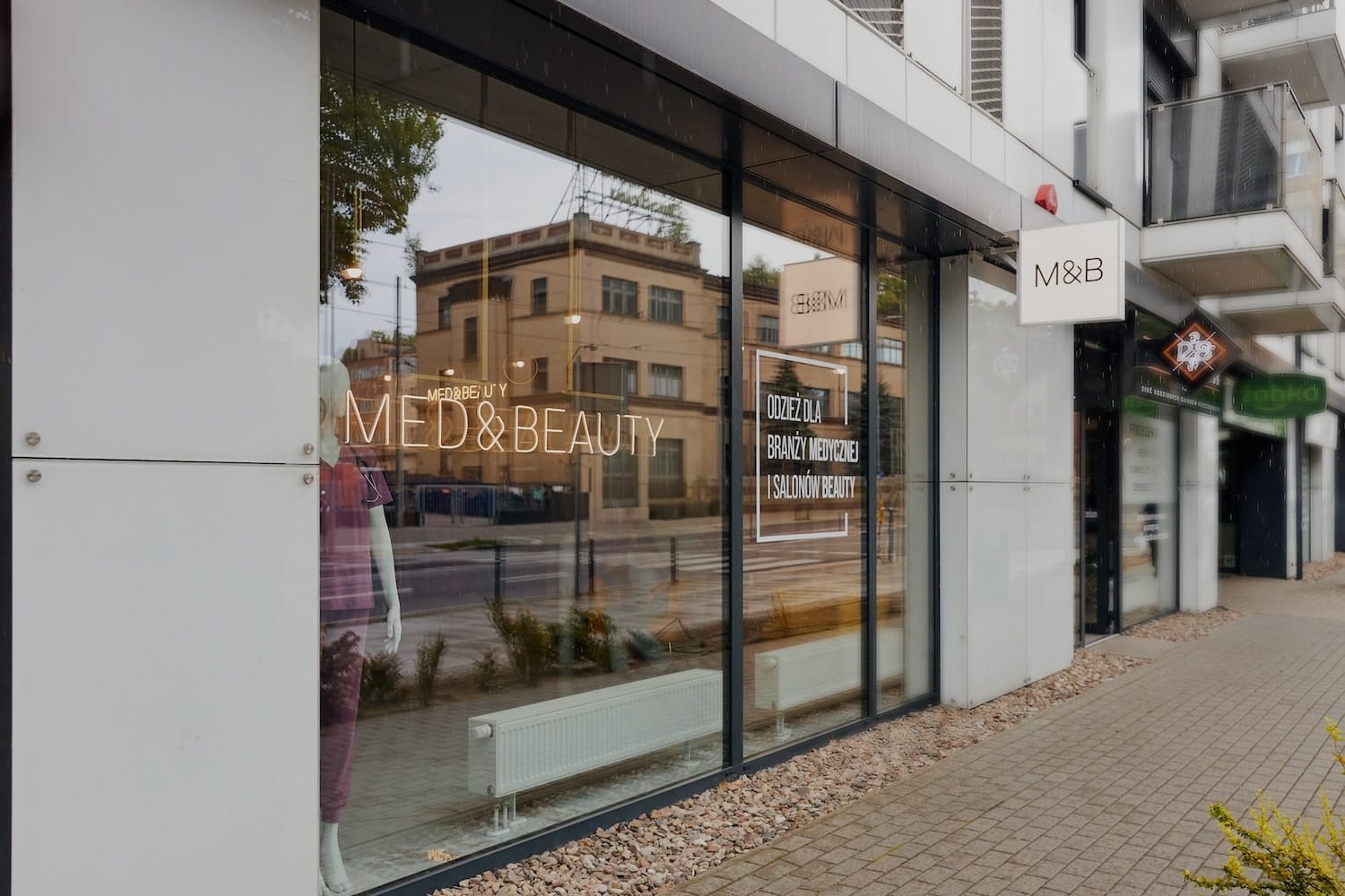 Widok na nowoczesną witrynę sklepu Med&Beauty z odzieżą dla branży medycznej i salonów beauty.